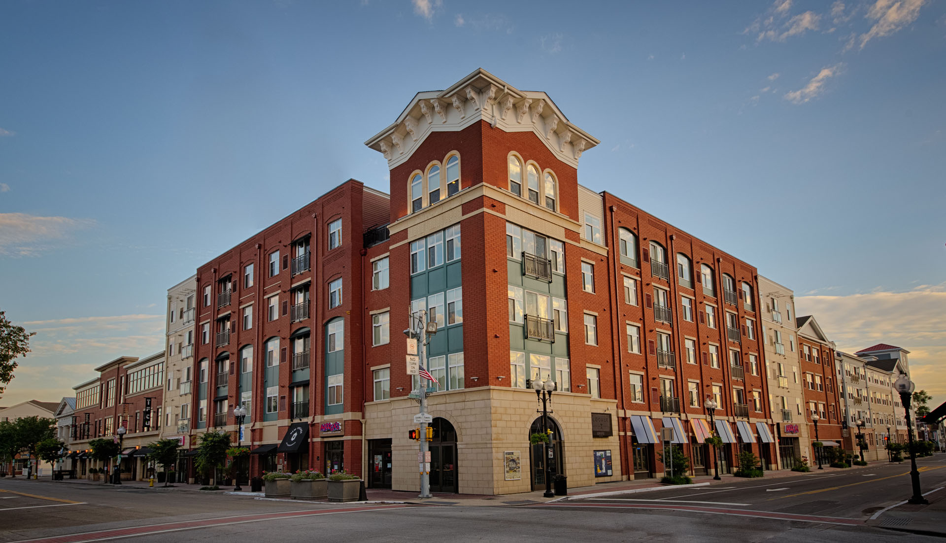 A large reddish-brown rental complex with a common entrance.